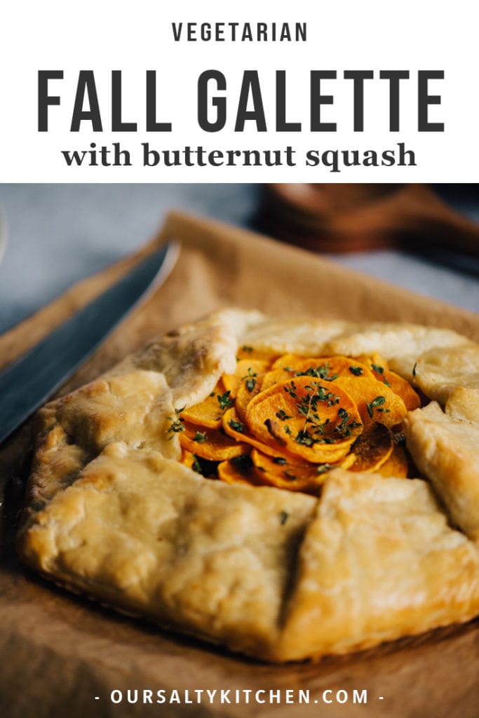 Butternut squash galette with caramelized onions, cheddar and thyme on a wood cutting board.