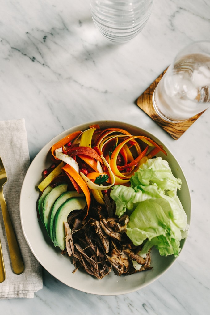 This raw carrot salad with parsnips is a sweet, crunchy and refreshing whole food recipe. It comes together quickly and pairs perfectly with pulled pork and avocado for easy, weeknight paleo tacos. #paleo #whole30 #realfood #wholefood