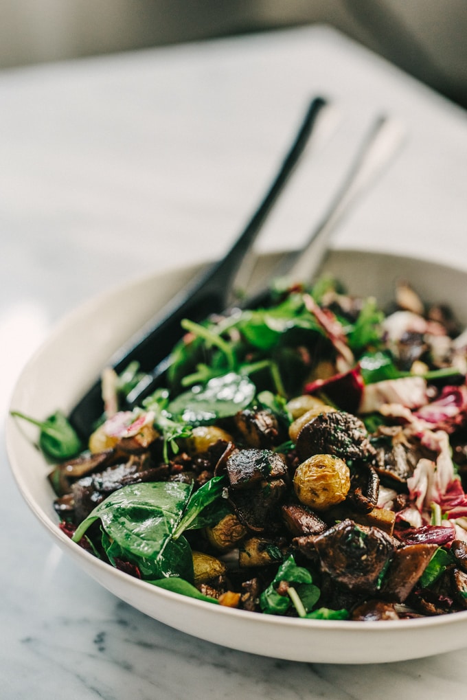 This warm mushroom salad with potato and wilted greens is one of my favorite fall salads. Crispy, pan-seared mushrooms are the star, tossed with roasted potatoes and fall greens for a hearty and satisfying meal. #paleo #wholefood #realfood #fall #autumn