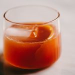 Classic old fashioned cocktail in a rocks glass with an orange peel garnish.