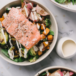 Grain bowls are all the rage, and I love them for both their simplicity and flexibility. This salmon grain bowl is made with leftover roasted vegetables, pan-fried salmon, sesame seeds, tahini dressing, and quinoa. It's a terrific way to use up leftovers and makes for a fast, easy, weeknight dinner.