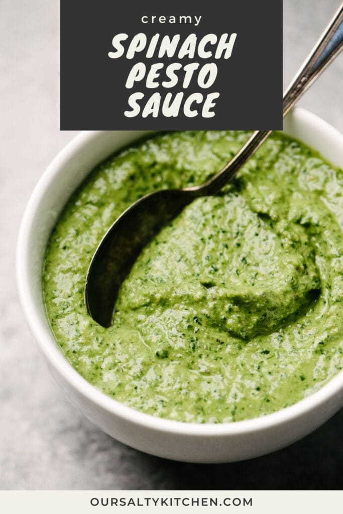 Side view, a spoon dipped into a bowl of creamy pesto sauce made with spinach; title bar at the top reads "creamy spinach pesto sauce".