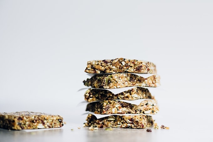 These nut-free paleo bars are slightly sweet and surprisingly nutty, with a texture that is both chewy and crunchy. Made with seeds, dried fruit, sunbutter and honey, these nut free paleo bars take only minutes to prepare and about an hour to chill. They are easy, healthy, and allergen friendly! 