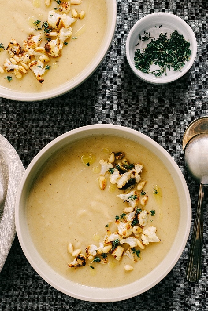 This roasted garlic and cauliflower soup is nutty and slightly sweet, with hints of bright flavor from the thyme and olive oil. Naturally grain-free and gluten-free, it's also friendly for vegetarian, paleo, and whole 30 diets. This soup freezes well for an fast and easy weeknight meal or lunch.