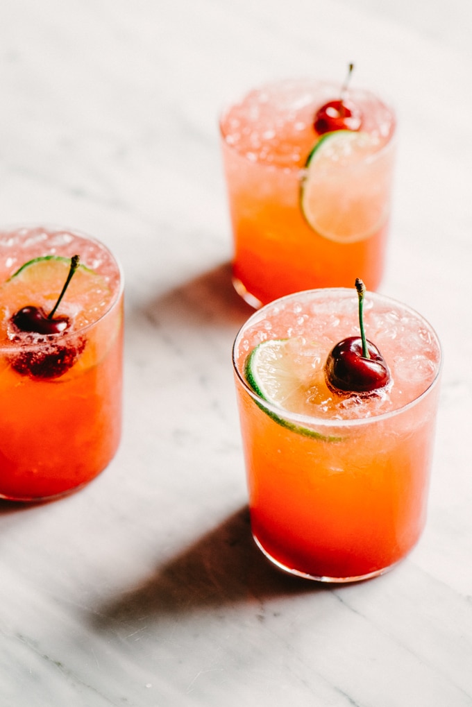 This Cherry Gin Rickey is liquid summer. It's a tart and refreshing summer gin cocktail with the perfect amount of sweet. You can easily make a large batch, so grab a few friends and get your rickey on.