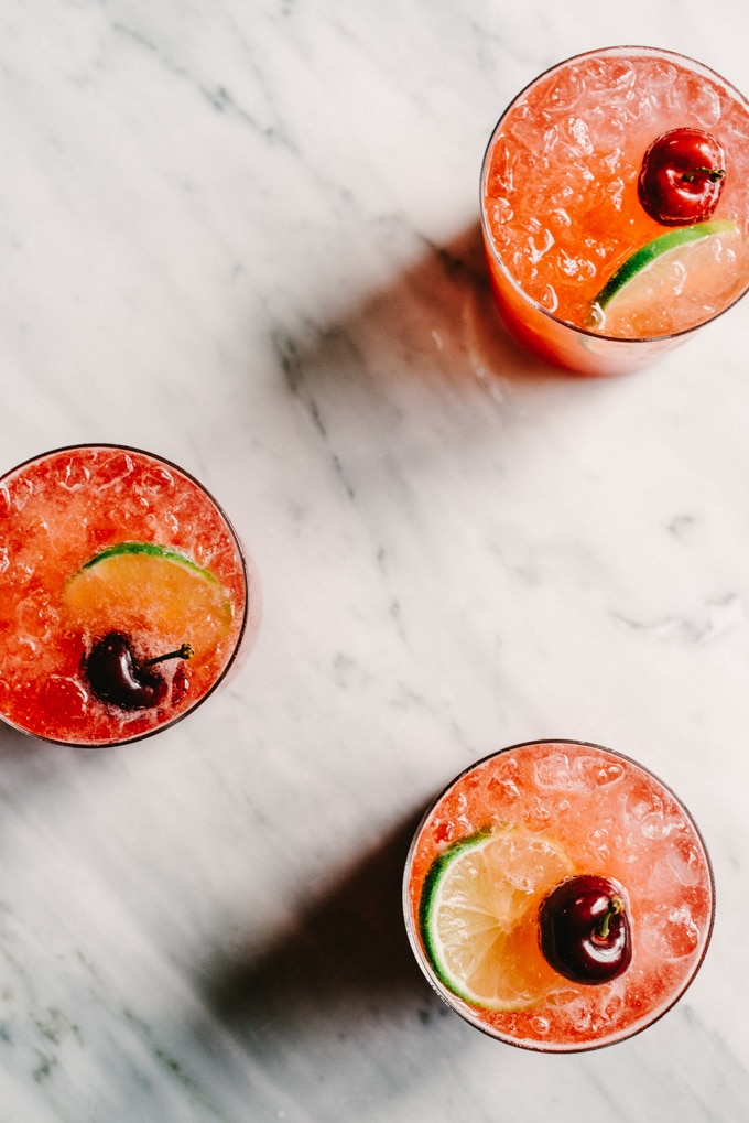 This Cherry Gin Rickey cocktail is liquid summer. It's tart and refreshing with the perfect amount of sweet. You can easily make a large batch, so grab a few friends and get your rickey on. #cocktail #cherry #summer