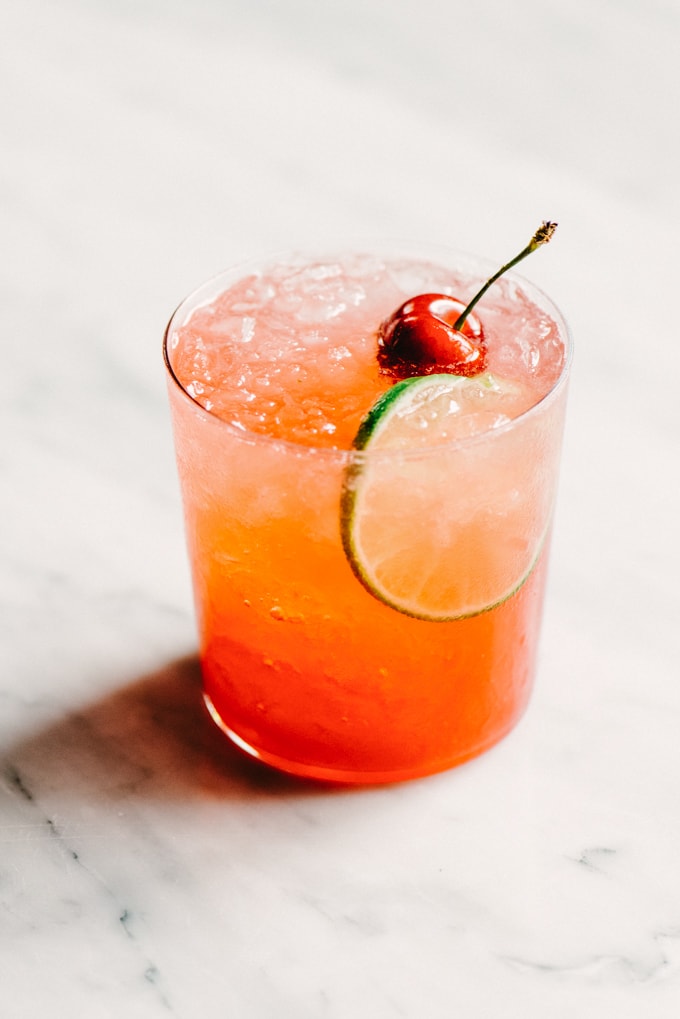 This Cherry Gin Rickey cocktail is liquid summer. It's tart and refreshing with the perfect amount of sweet. You can easily make a large batch, so grab a few friends and get your rickey on. #cocktail #cherry #summer