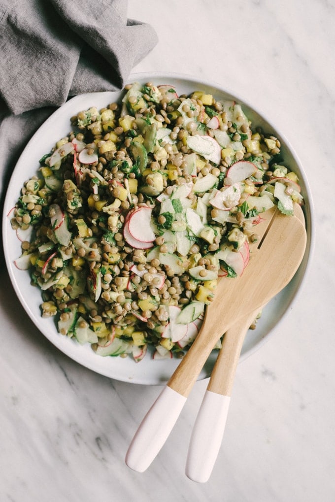 This whole food lentil salad with poached eggs is crunchy, fresh, and tangy. This real food recipe is packed with protein and makes for an easy packed lunch or fast weeknight dinner. #healthy #wholefood #realfood #vegetarian