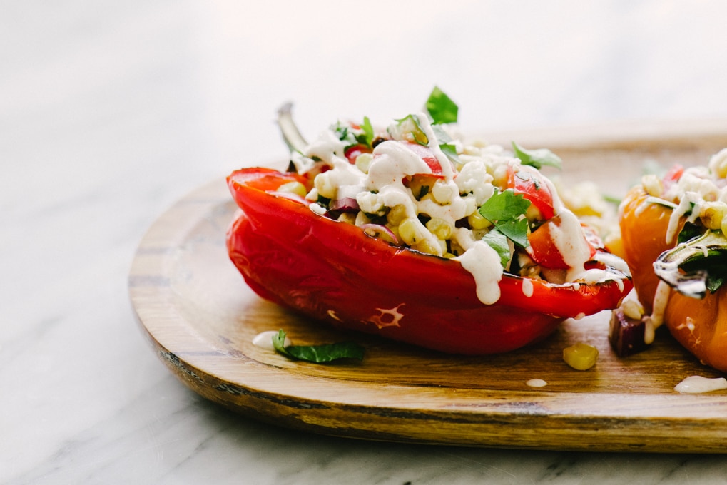 These grilled mexican street corn stuffed peppers are a fast, easy, no-oven-required recipe. They are packed with veggies (and flavor!) and make for a delicious light lunch, or easy side dish. Stretch this dish even further by adding a few cups of cooked black beans to the filling.