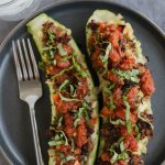These Italian sausage zucchini boats are an easy, paleo weeknight dinner! They're an easy recipe the entire family will love. #paleo #weeknight #zucchiniboats #stuffedzucchini
