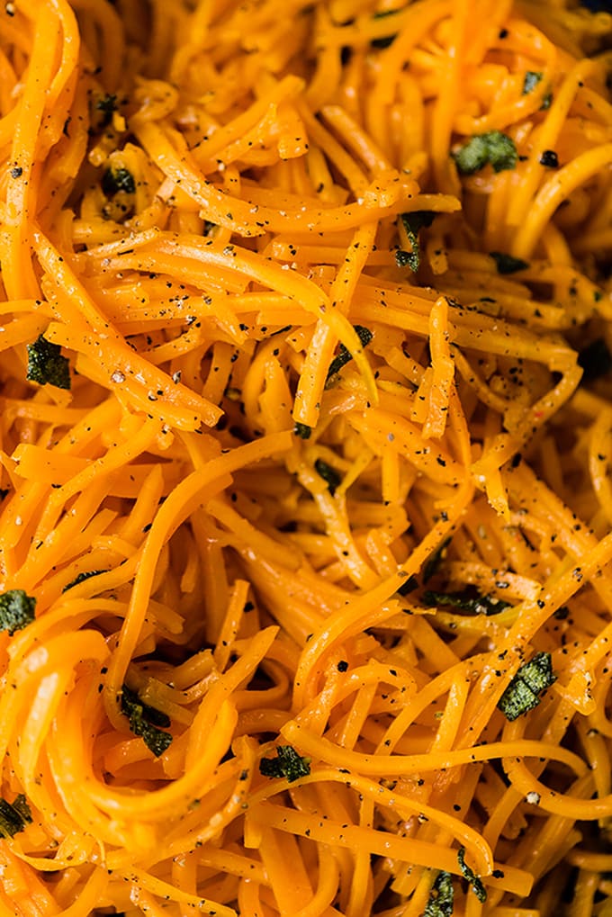 A detail image of my go-to butternut squash noodle recipe - julienne butternut squash noodles roasted and tossed with crispy sage butter, salt, and a pepper. 