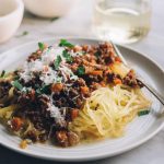 This crockpot bolognese is an easy, kid friendly gluten free meal. Packed with real, whole foods, it's a savory, hearty, weeknight meal that is perfect for chilly winter nights. Start this bolognese in the slow cooker first thing in the morning and enjoy this healthy, hearty meal after work!