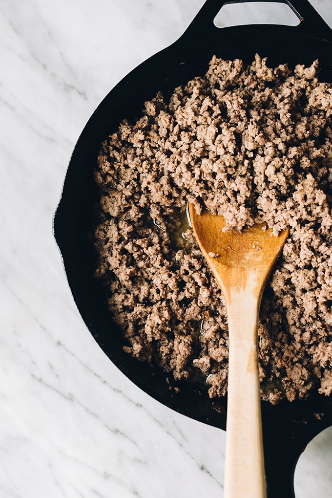 How to make crockpot bolognese, an easy, kid friendly weeknight dinner! The base starts with browned grass fed ground beef.