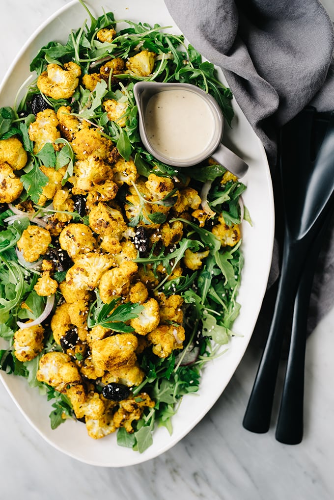 This sweet and salty turmeric roasted cauliflower salad is a quick and easy weeknight recipe. It's vegetarian, gluten free, and ready in 30 minutes! #vegetarian #wholefoods #cauliflower #salad #30minutemeal