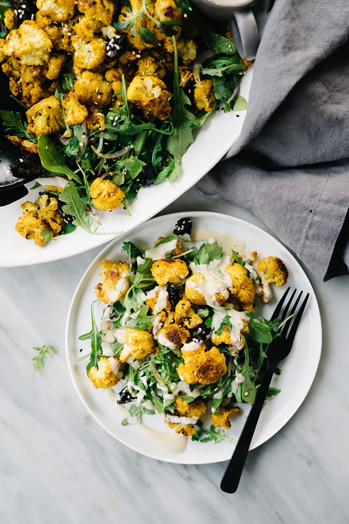 This sweet and salty turmeric roasted cauliflower salad is a quick and easy weeknight recipe. It's vegetarian, gluten free, and ready in 30 minutes! #vegetarian #wholefoods #cauliflower #salad #30minutemeal