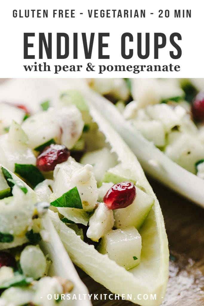 Cocktail appetizer endive cups stuffed with pears, pomegranate, and blue cheese.