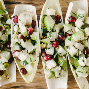 These endive cups are a fast, easy, and healthy holiday party appetizer. They're naturally vegetarian and gluten free, and bursting with flavor. The beautiful green hues and pops of red are seasonal and cheerful. Yum! #glutenfree #vegetarian #appetizer #holidayparty #christmasrecipe #winterrecipe