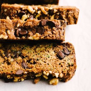 Three slices of fresh baked paleo zucchini bread with walnuts and chocolate chips.