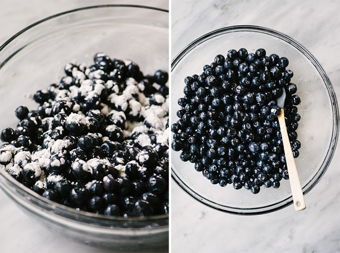 A large mixing bowl filled with fresh blueberries tossed with cornstarch, honey, and lemon for gluten free blueberry cobbler.