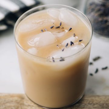 An iced london fog tea latte brewed with lavender and sweetened with vanilla extract, stevia, and cashew milk. A healthy, refreshing paleo iced tea latte!