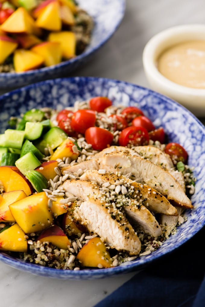 Light and refreshing summer quinoa salad with chicken, summer vegetables, and creamy sunbutter sauce.