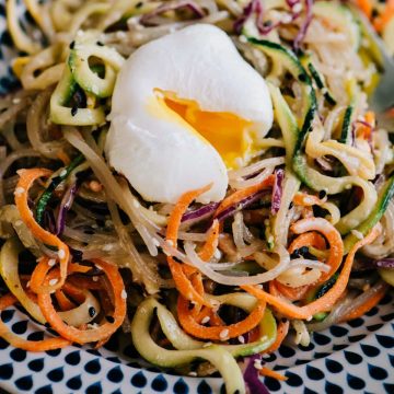 Paleo glass noodle salad with sesame ginger dressing and a poached egg.