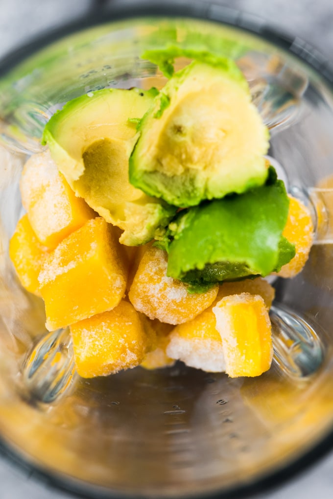 Avocado and diced frozen mango in a blender.