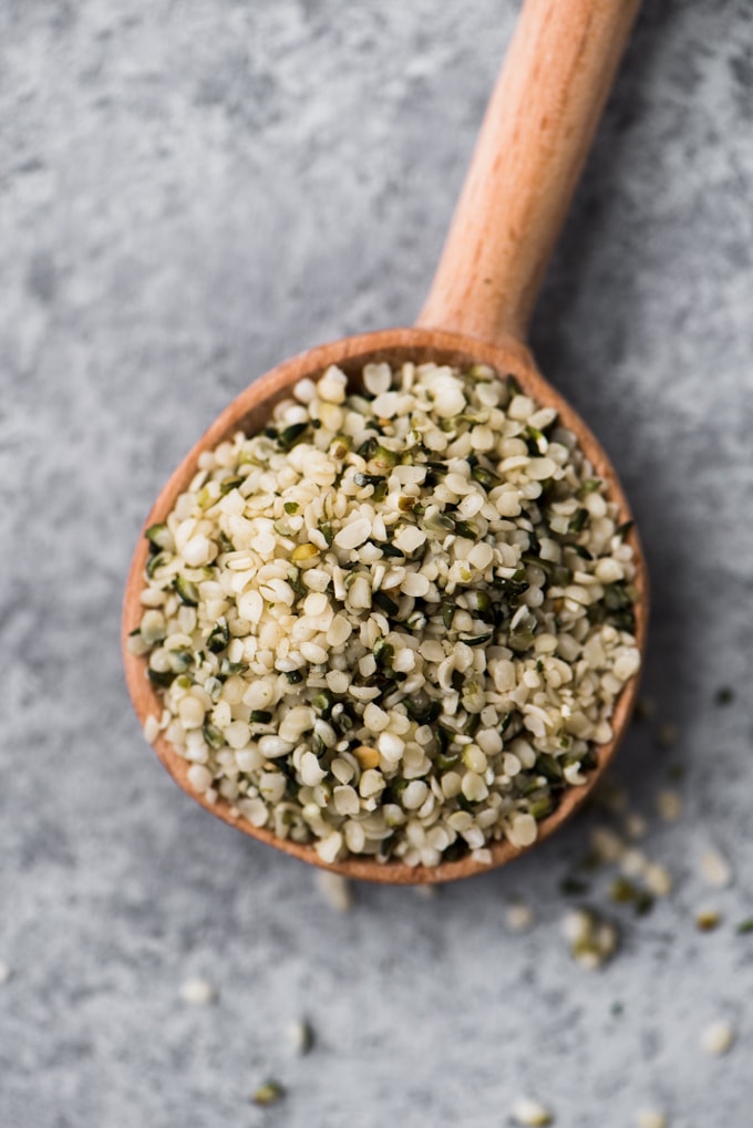 A small wooden spoon filled with protein packed hemp seeds.