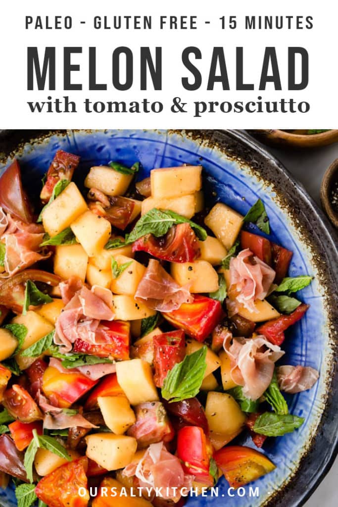 Summer melon salad with tomato and prosciutto in a large bowl garnished with basil and mint.