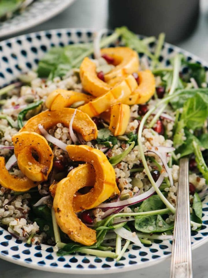 A vegetarian and gluten free delicata squash salad with creamy maple dressing.