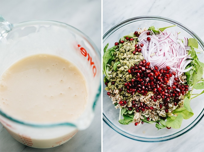 Maple vinaigrette in a spouted jar and a mixing bowl filled with quinoa, arugula, pomegranate, red onion, and pepitas.
