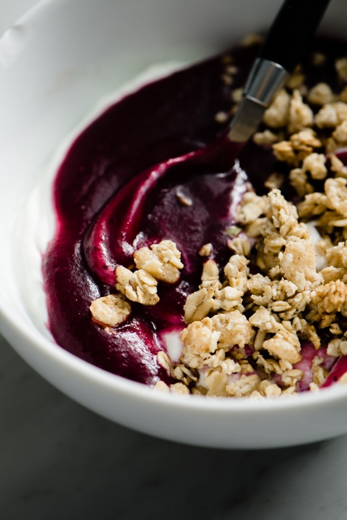 Greek yogurt topped with homemade blueberry applesauce and granola.