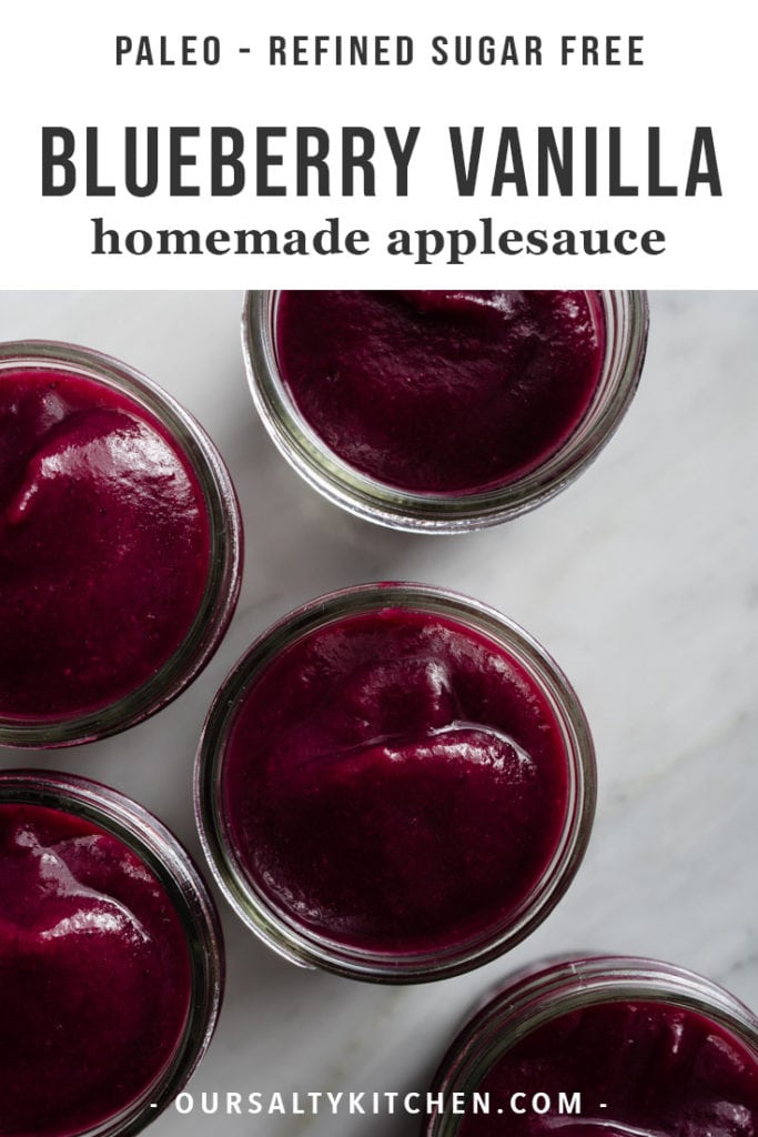 Several glass canning jars filled with homemade vanilla blueberry applesauce.