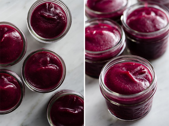Smooth vanilla infused blueberry applesauce in small glass jars.