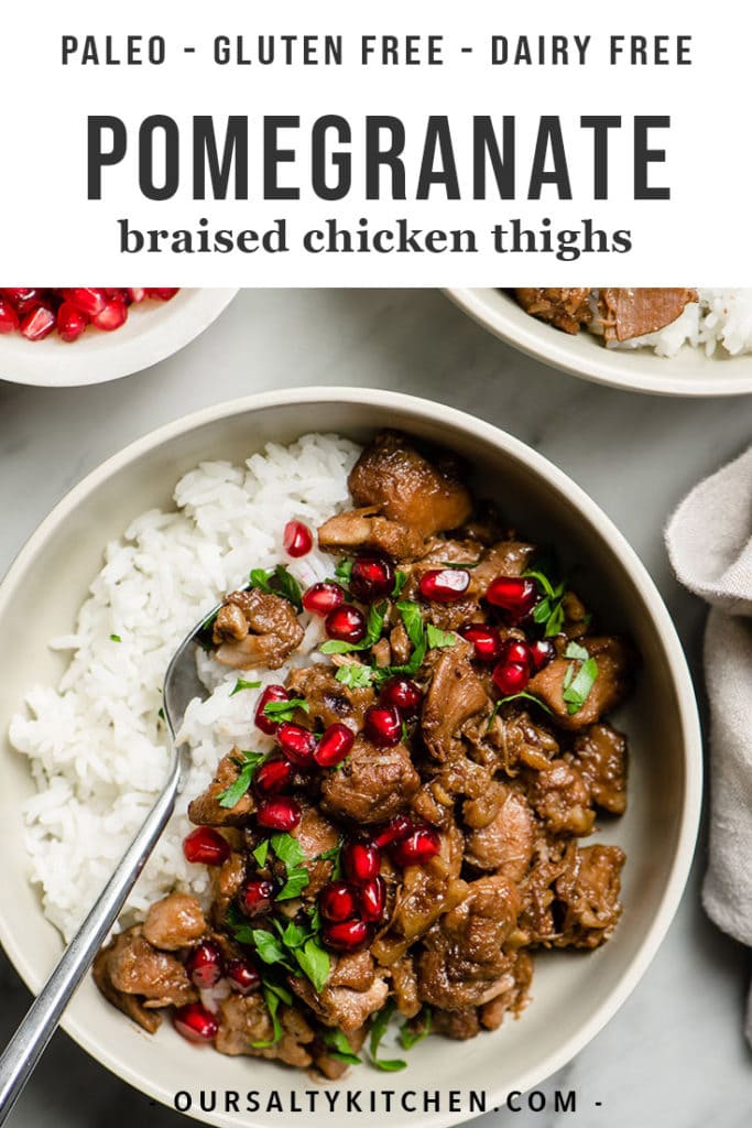 A bowl of braised pomegranate chicken over white rice garnished with parsley and pomegranate seeds.