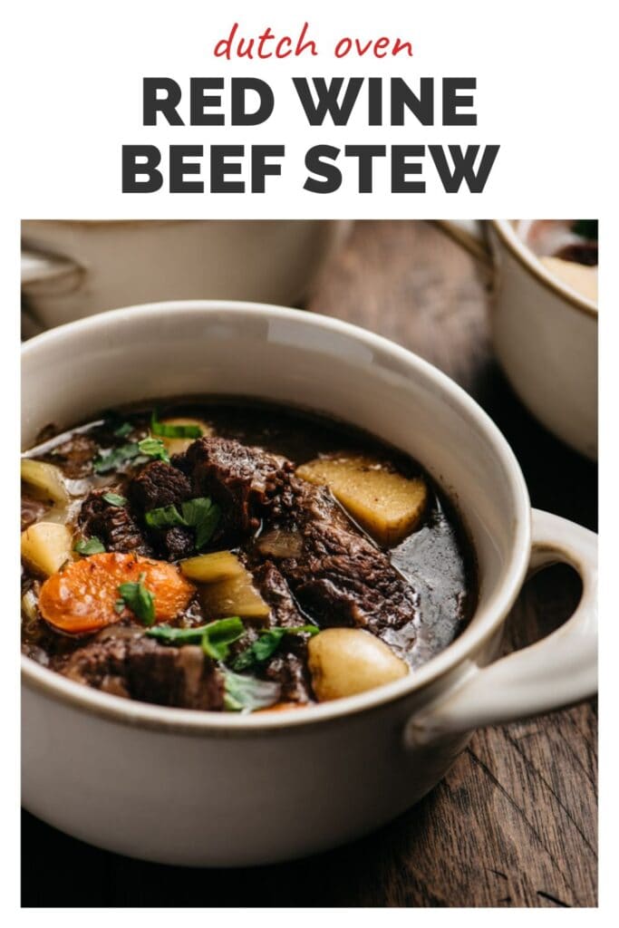 From the side, red wine beef stew in a bowl garnished with fresh parsley with a title bar at the top that reads "dutch oven red wine beef stew".