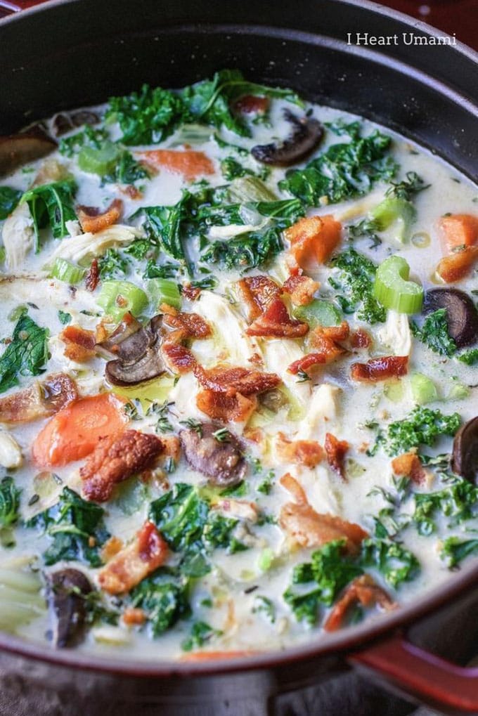A pot of creamy chicken and kale whole30 soup with bacon. 