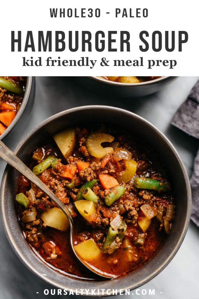 A bowl of hearty kid friendly whole30 hamburger soup in a grey bowl on a marble table.