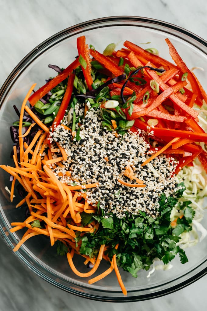 Citrus asian slaw ingredients without dressing in a glass bowl.