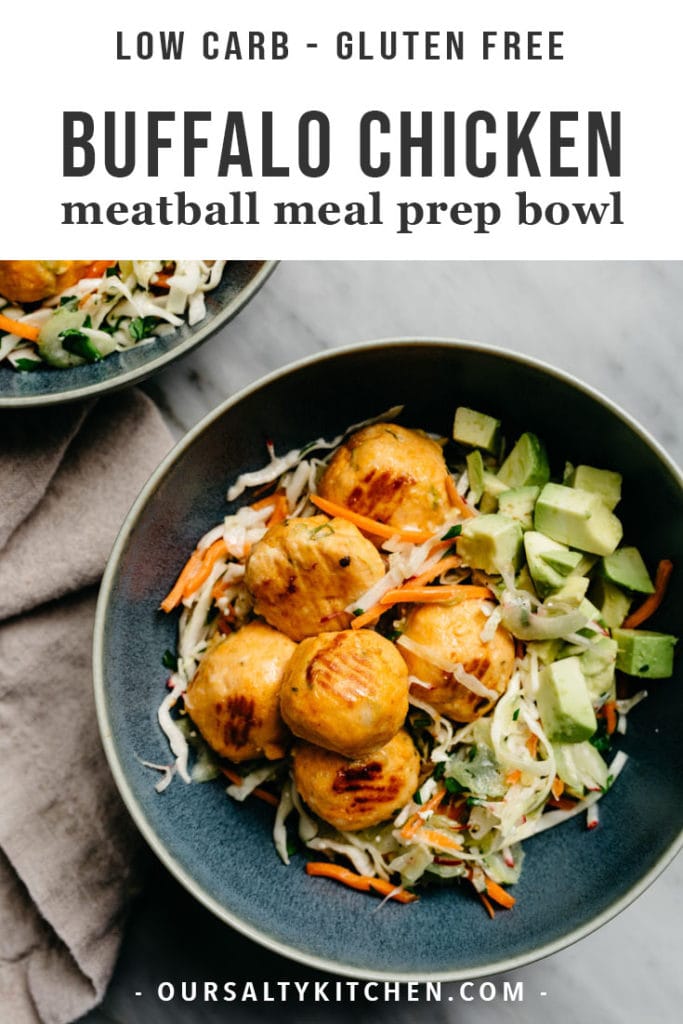 Oven baked buffalo chicken meatballs over coleslaw with avocado in a blue bowl.