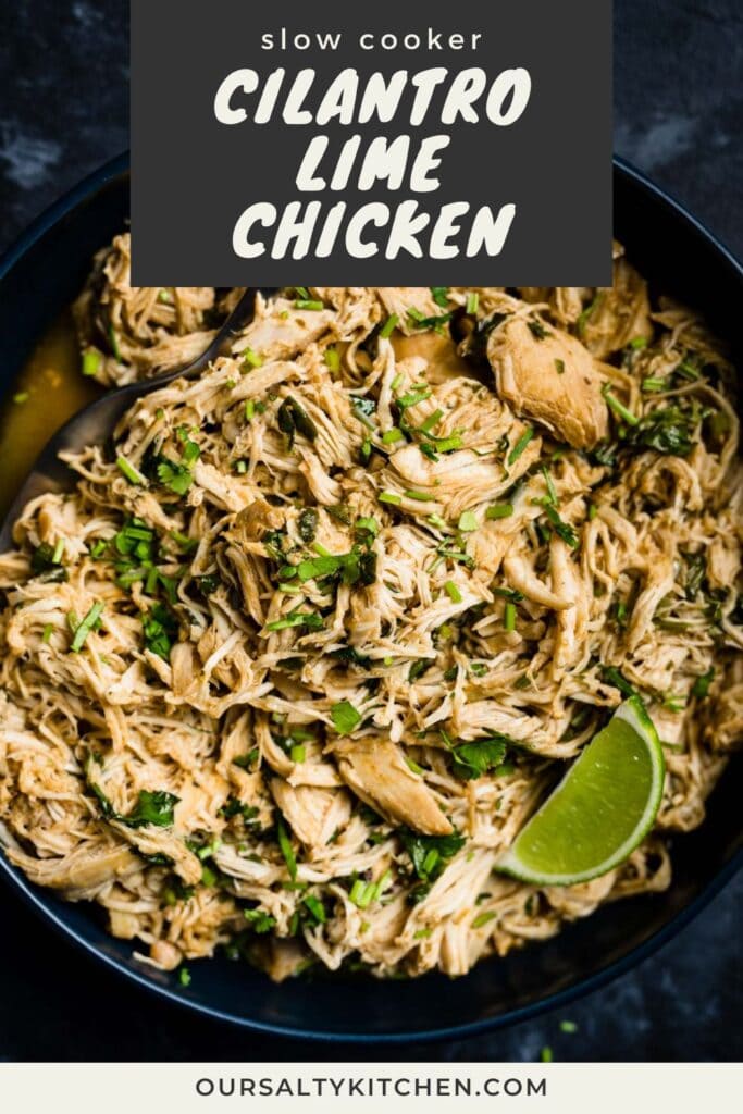 A serving spoon tucked into a bowl of shredded cilantro lime chicken, garnished with a lime wedge and lots of fresh cilantro; title bar at the top reads "slow cooker cilantro lime chicken".