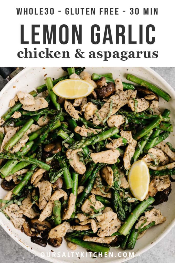 Lemon garlic chicken and asparagus recipe in a skillet with lemon wedges and fresh basil.