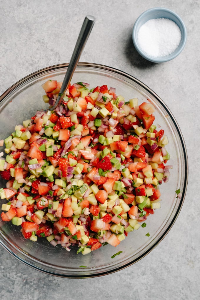 A prep bowl filled with freshly made vegan strawberry avocado salsa.