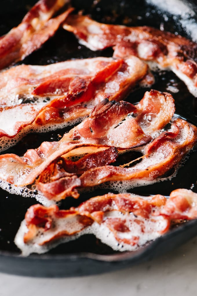 Crispy bacon in a cast iron skillet.