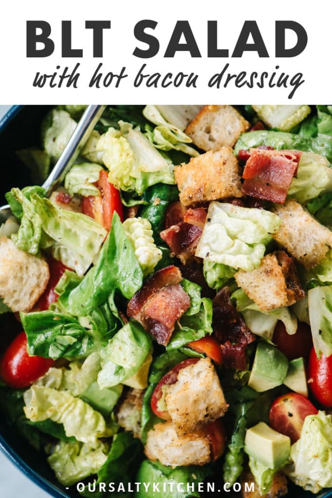 From above, a close-up of a BLT salad with avocado and hot bacon dressing.