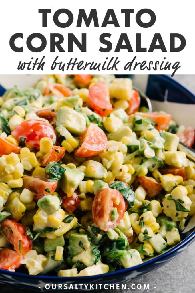 A blue and white bowl of tomato corn salad with avocado and buttermilk dressing and text bar at the top for Pinterest.