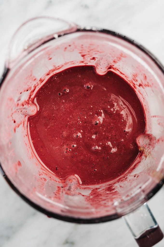 A vegan cherry smoothie in a blender.