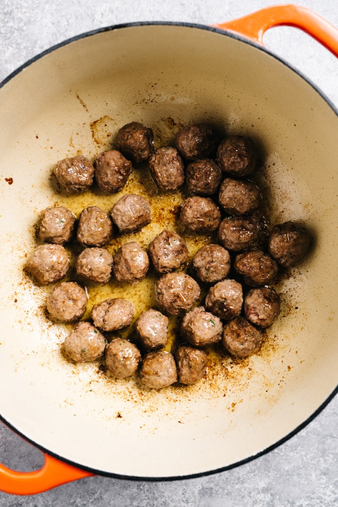 Mini swedish meatballs browned in a dutch oven.
