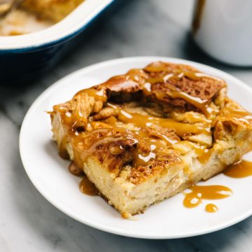 A slice of apple bread pudding drizzled with salted caramel sauce.