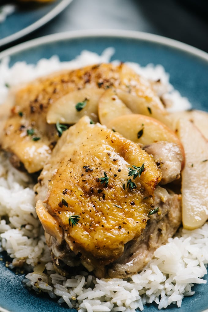 Apple cider chicken thighs over white rice with sautéed apples.